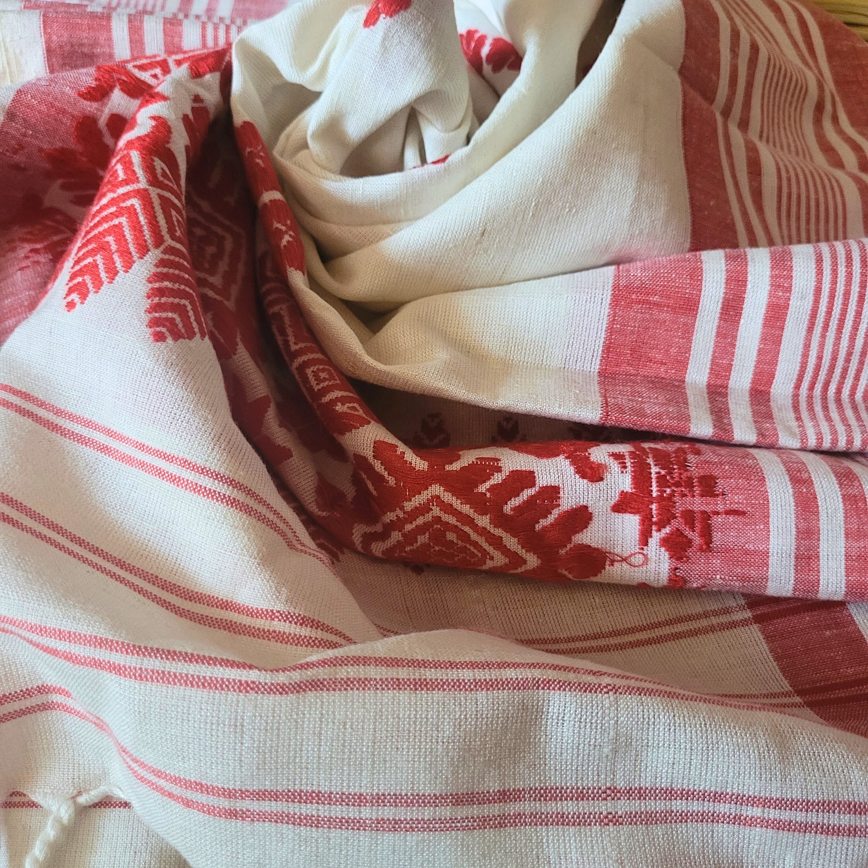 Red and white patterned fabric with a focus on texture and color.
